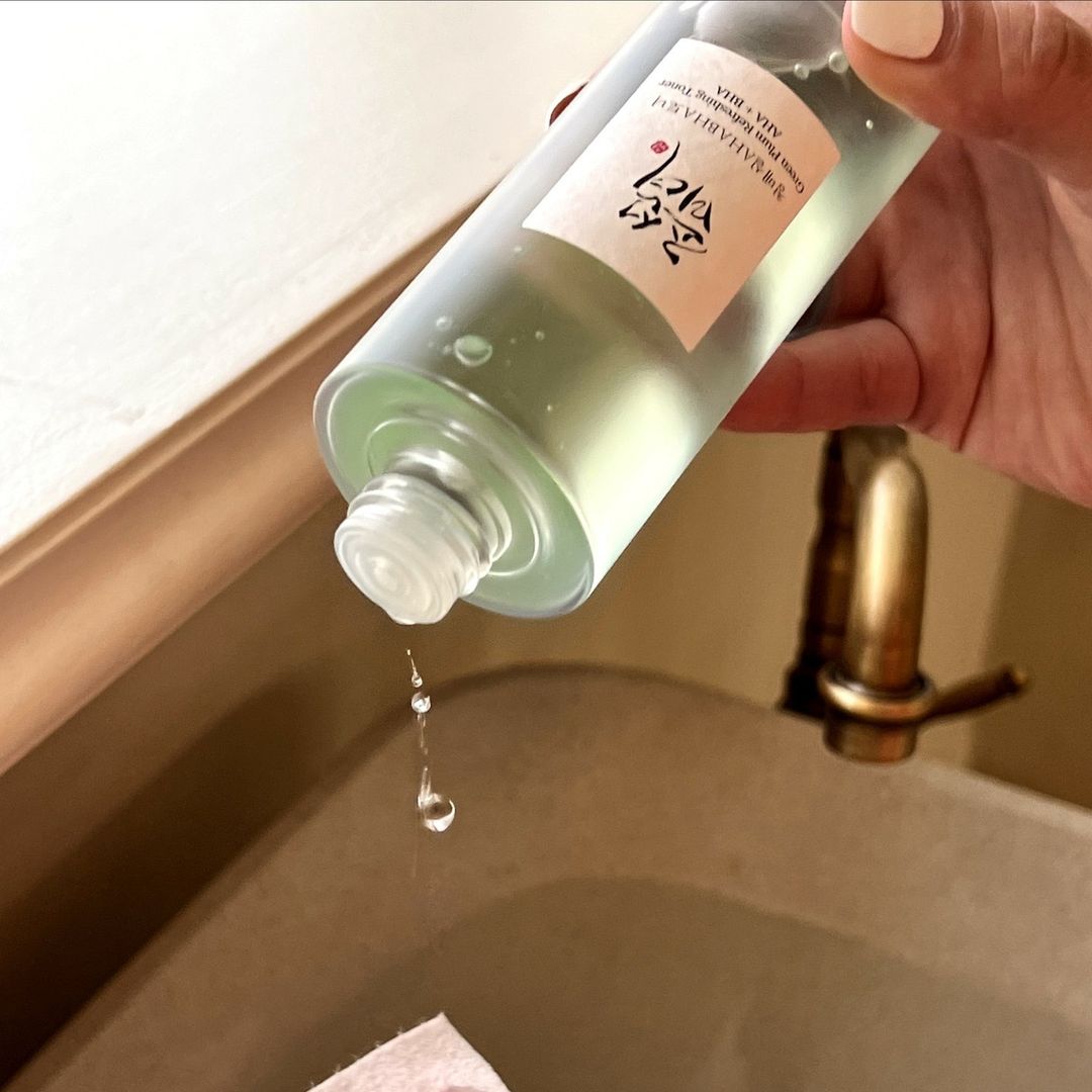Beauty of Joseon Green Plum Refreshing Toner AHA + BHA being poured onto cotton pad